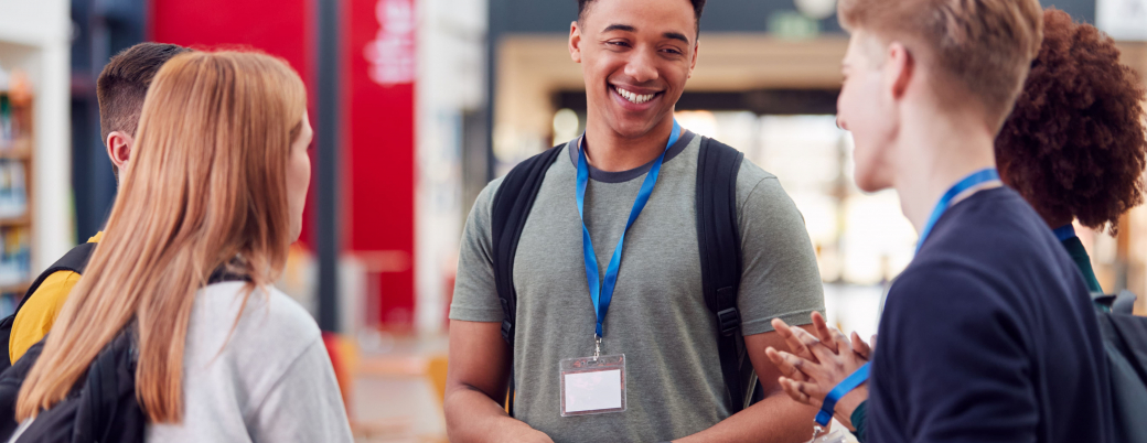 Trois jeunes qui portent un badge discutent lors d'un salon sur le numérique
